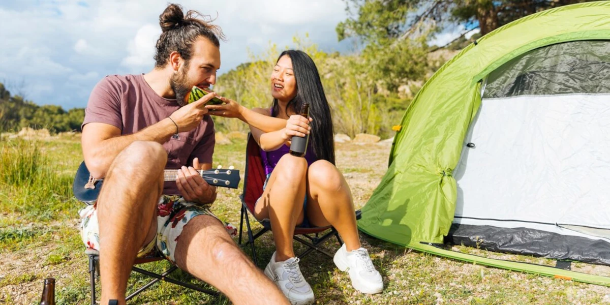 Couple eating next to a campsite