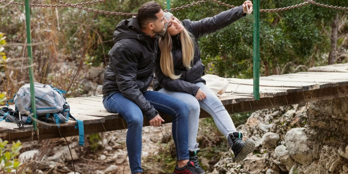 Couple taking a photo on a bridge