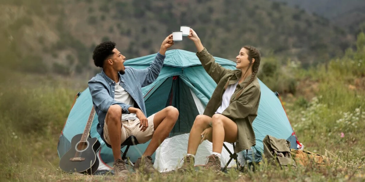 Couple toasting in front of a tent