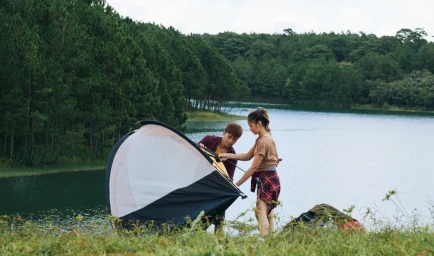 People setting up a tent on the river card