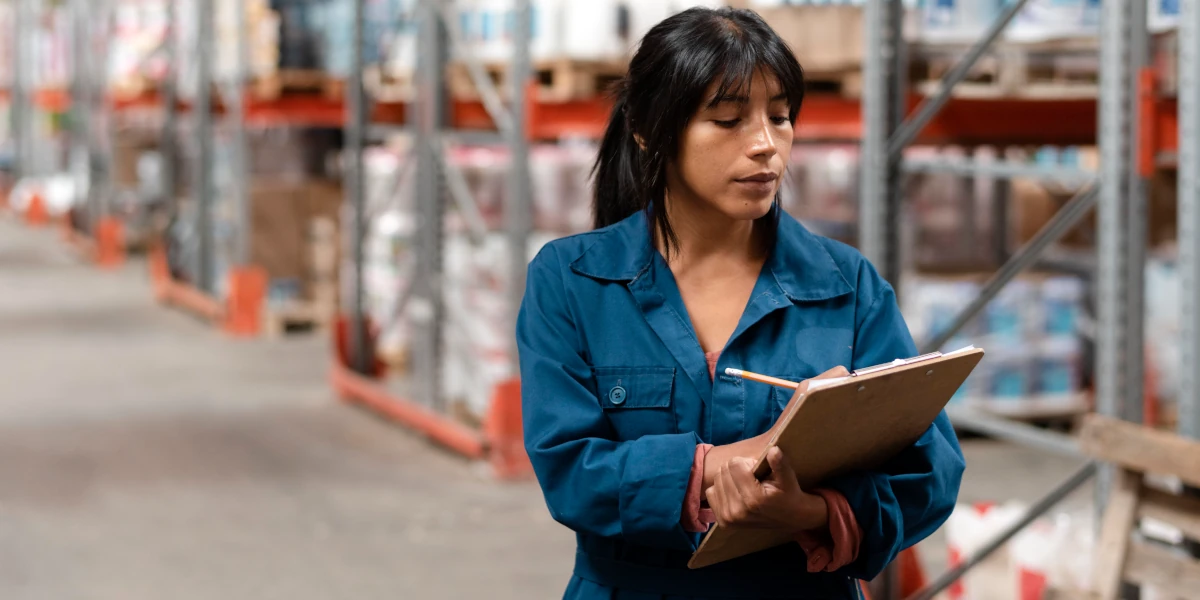 Delivery driver taking notes in warehouse