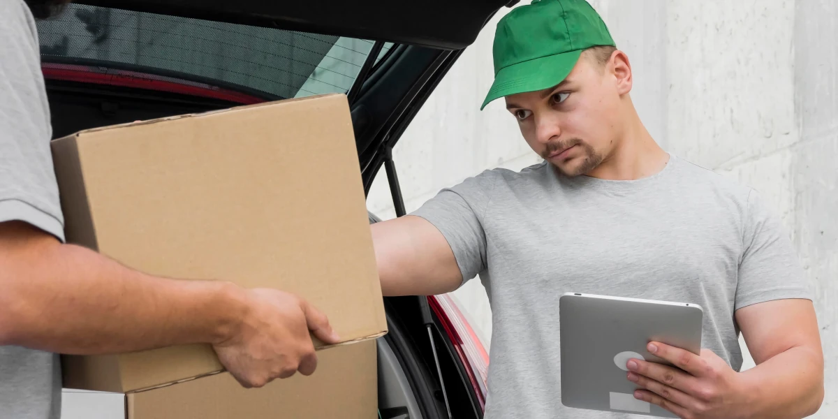 Delivery driver verifying delivery with tablet