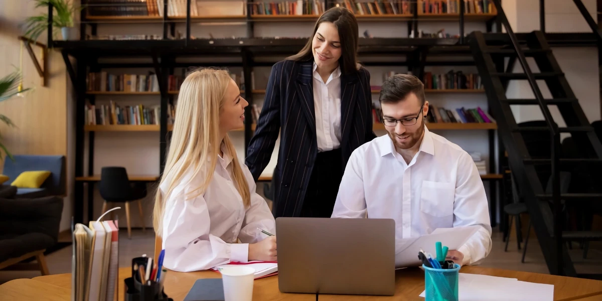 Approach-young-entrepreneur-doing-internship at a table
