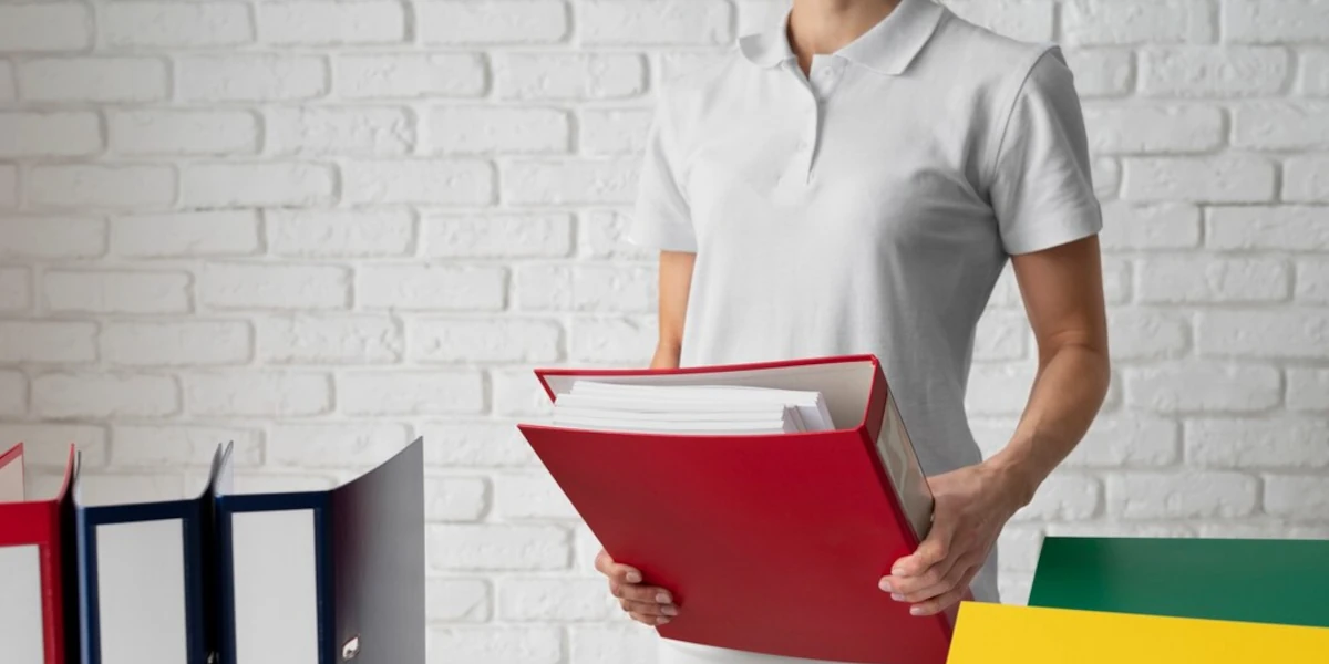 Woman holding ring binder used for document storage