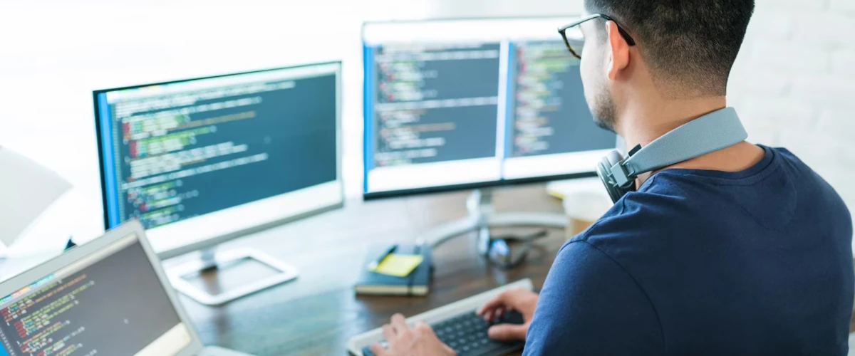 young software developer programming while working